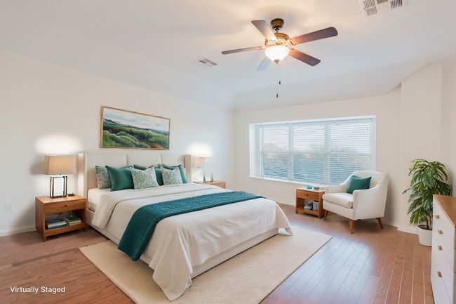 Primary, Bedroom with visible vents, baseboards, a ceiling fan, and light wood finished floors | Image 28