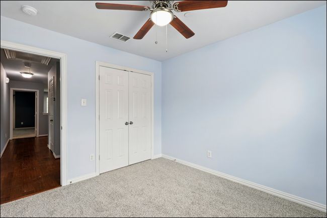 Unfurnished bedroom with visible vents, a closet, baseboards, attic access, and carpet | Image 26