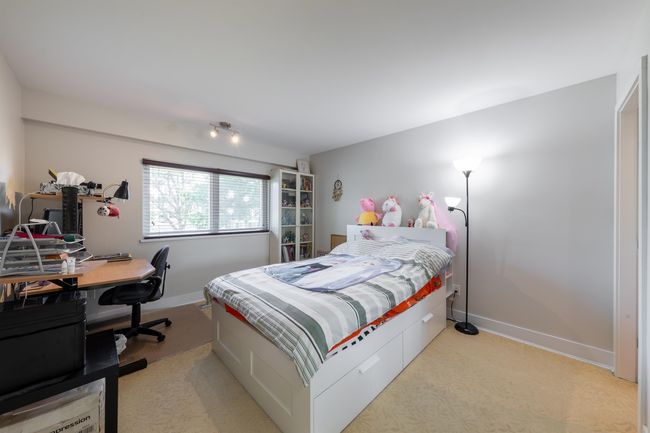 Bedroom featuring baseboards, light colored carpet, and a desk | Image 20