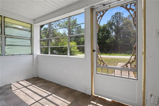 Unfurnished sunroom with healthy amount of natural light | Image 5