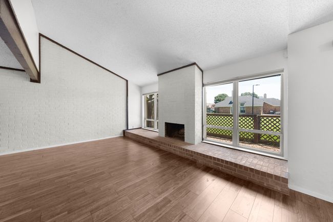 Close up of fireplace with greenbelt views beyond. | Image 7