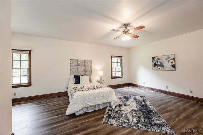 Bedroom featuring wood finished floors, baseboards, and ceiling fan | Image 17