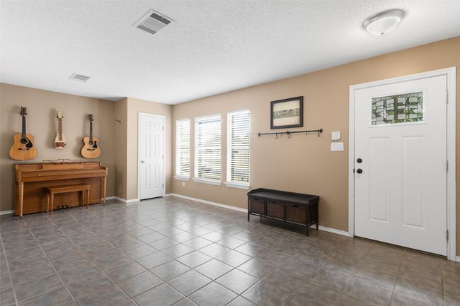 Charming entryway ideal for a music room or cozy sitting room. | Image 5