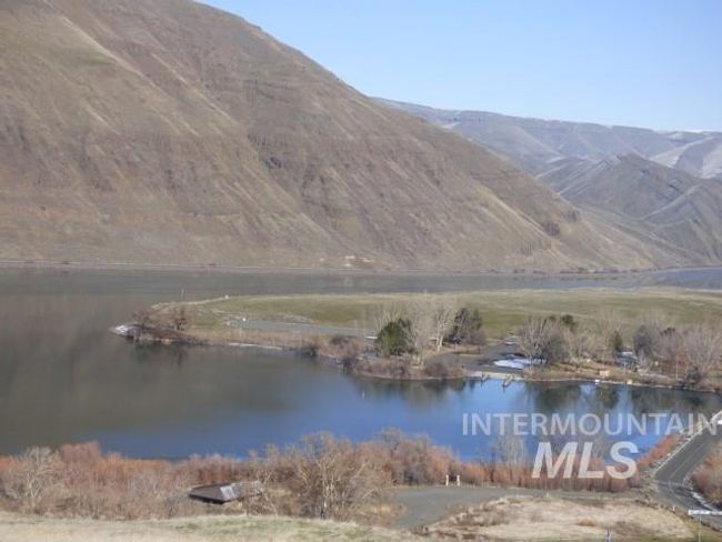 View of mountain backdrop featuring a nearby body of water | Image 45