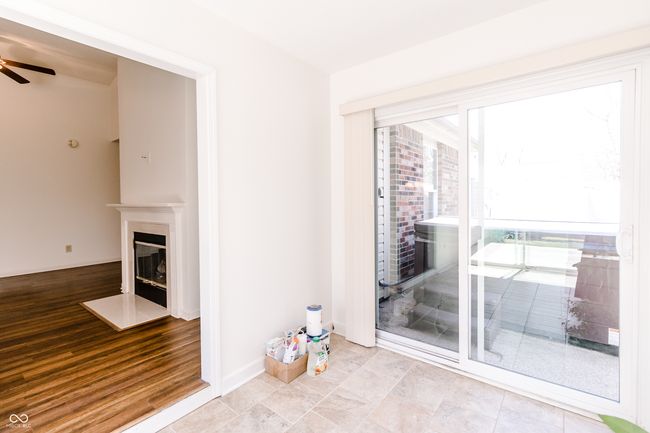 unfurnished living room with a fireplace with flush hearth and ceiling fan | Image 26