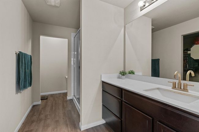 Full bathroom featuring wood finished floors, vanity, and an enclosed shower | Image 16