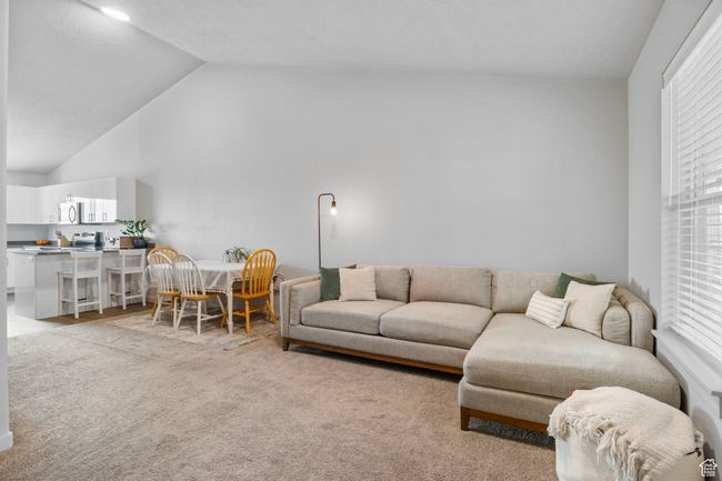 Living room featuring light carpet and high vaulted ceiling | Image 9