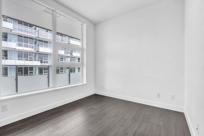 Spare room with dark wood finished floors and baseboards | Image 11