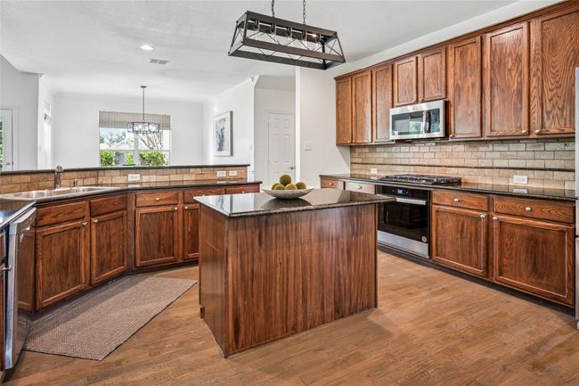 Huge kitchen has both an island and food service counter | Image 13