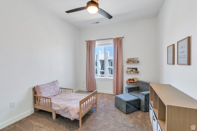 Carpeted bedroom featuring visible vents, baseboards, and ceiling fan | Image 12