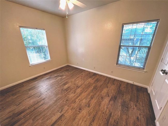 Spare room featuring dark wood finished floors and ceiling fan | Image 10