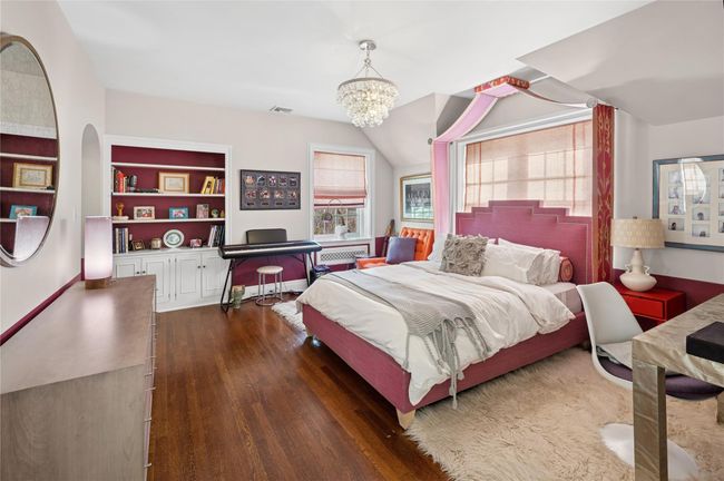 Spacious Fifth Bedroom featuring large windows a chandelier, wood finished floors | Image 31