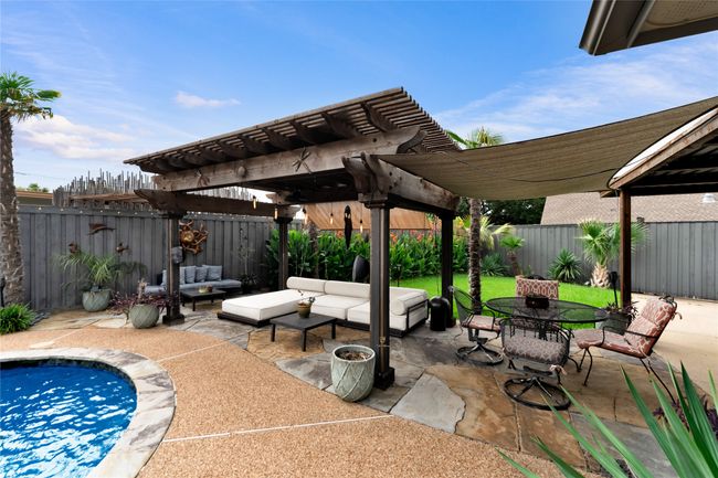 Fenced backyard featuring a pergola, an outdoor living space, a patio area, and outdoor dining space | Image 30