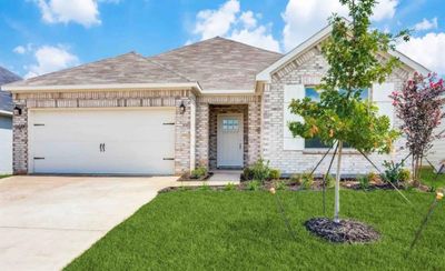 View of front of home featuring a front yard and a garage | Image 1