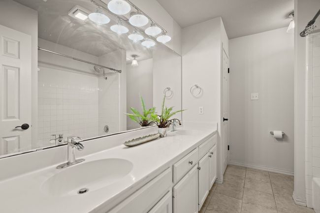 Bathroom featuring double vanity and light tile patterned flooring | Image 19