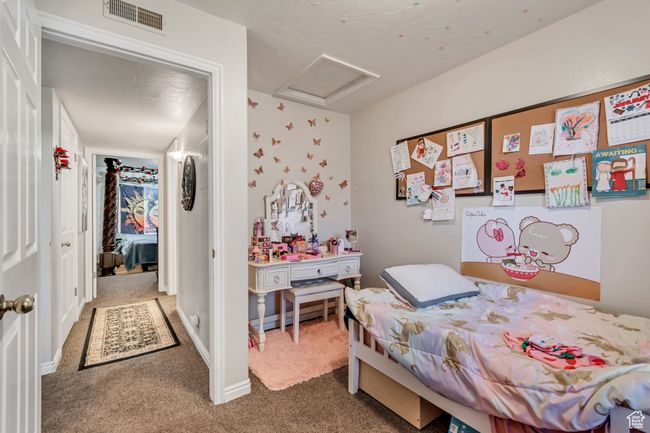 Carpeted bedroom with attic access | Image 11