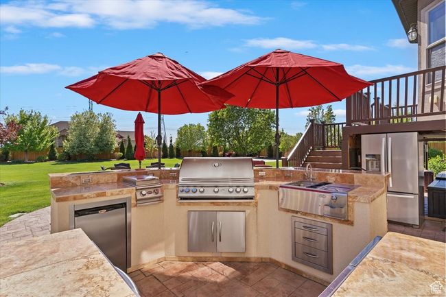 View of patio with a wooden deck, grilling area, stairway, and area for grilling | Image 54