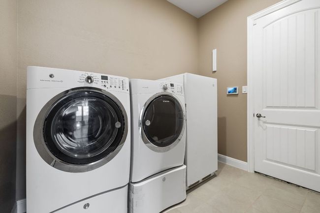 Laundry room with door to garage | Image 26