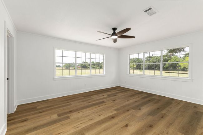 Wake up to serene pond views from the spacious primary bedroom. | Image 19