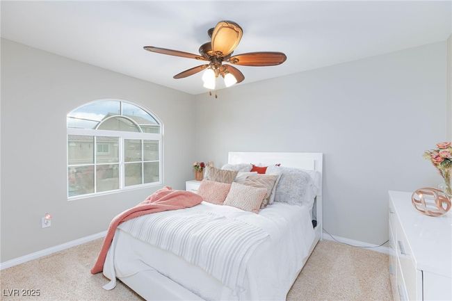 Bedroom with ceiling fan, light carpet, and baseboards | Image 33
