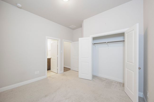 Unfurnished bedroom with carpet floors, a closet, and ensuite bathroom | Image 10