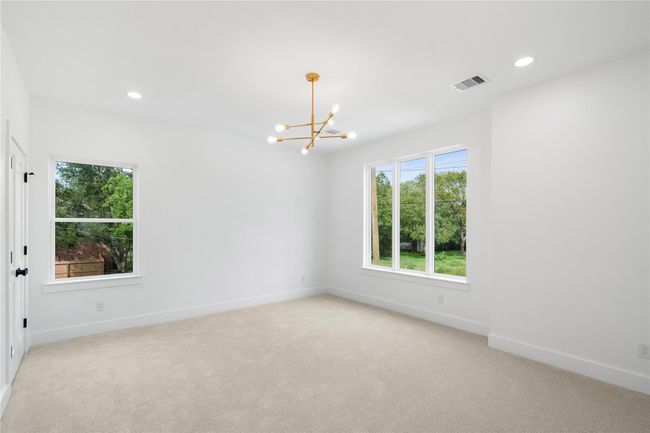 This bedroom offers spa-like bathroom and walk-in custom closet | Image 24