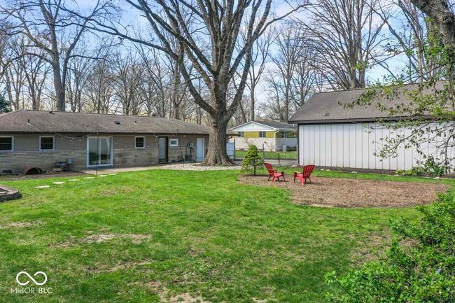 view of yard featuring a patio area, a fire pit, and fence | Image 30