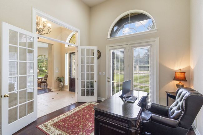 Office area featuring french doors, plenty of natural light, dark wood-type flooring, and a towering ceiling | Image 7