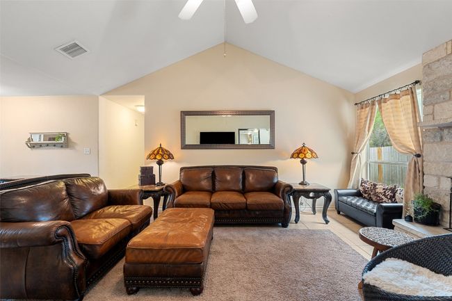 Living area with lofted ceiling, a ceiling fan, and tile patterned flooring | Image 11