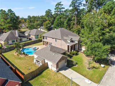 Aerial view showing the main house and separate garage/pool house. | Image 2