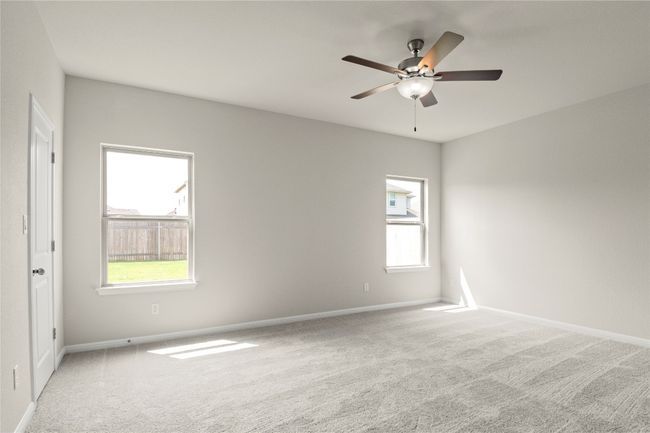 Spare room featuring carpet, healthy amount of natural light, and ceiling fan | Image 19