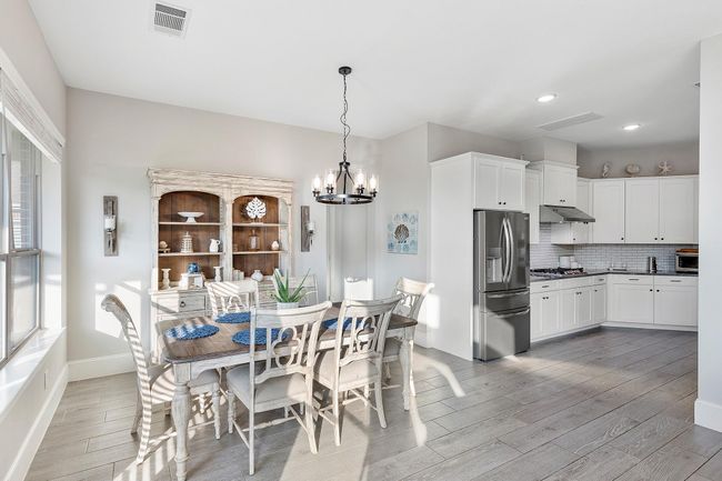 Gather and create memories in the inviting dining area, seamlessly connected to the kitchen and living spaces—ideal for family meals and entertaining guests. | Image 14