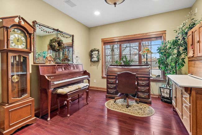 Office with mahogany hardwood floors. Viewed from main hallway with windows to the front yard and acre size pond. Ceiling speakers connected to whole house audio. | Image 14
