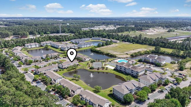 Aerial view of property's location featuring a nearby body of water and a forest | Image 26
