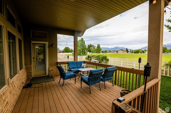 Deck featuring a mountain view and an outdoor living space | Image 47