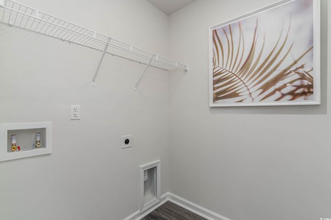 Laundry area with hookup for an electric dryer, baseboards, washer hookup, and dark wood-style floors | Image 20