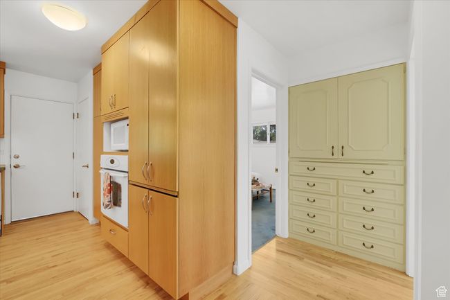 Kitchen featuring white appliances and light wood-type flooring | Image 17