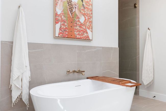Full bath featuring tile patterned floors, a soaking tub, and tile walls | Image 28