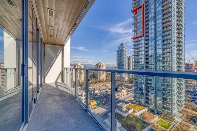 Balcony with a view of city and visible vents | Image 12