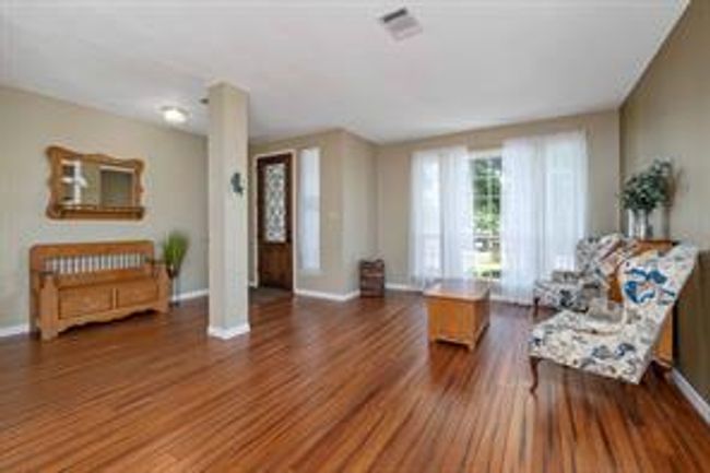 Sitting room featuring visible vents, baseboards, and wood finished floors | Image 14