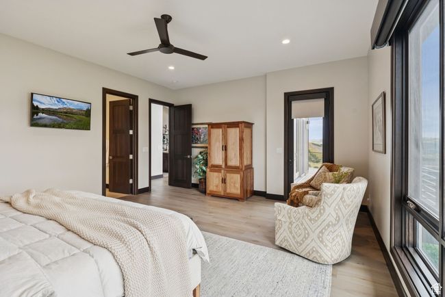 Bedroom with light wood finished floors, recessed lighting, ceiling fan, and access to outside | Image 33