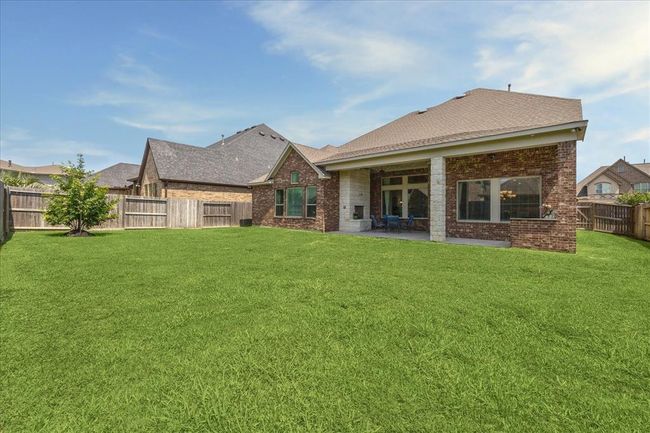 Sprawling blank canvas backyard ready for your own stamp - sky is the limit here. A home that highlights layout and entertaining with room to grow – welcome home to 18311 Windspring Falls. | Image 31