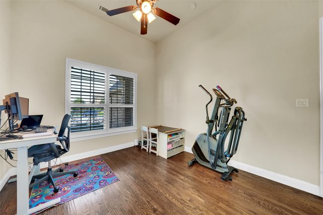 Office featuring dark wood finished floors and ceiling fan | Image 31
