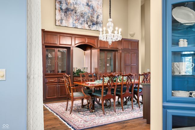 dining room with an inviting chandelier, dark wood finished floors, and a high ceiling | Image 17