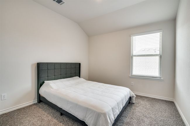 Carpeted bedroom featuring vaulted ceiling and baseboards | Image 23