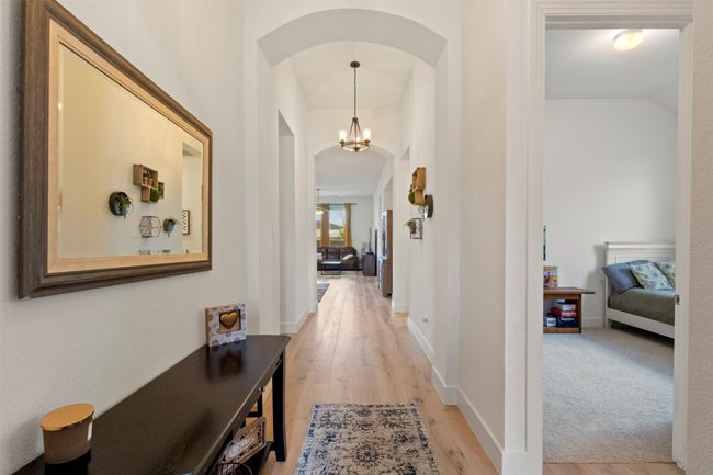 Corridor with arched walkways and light wood finished floors | Image 4