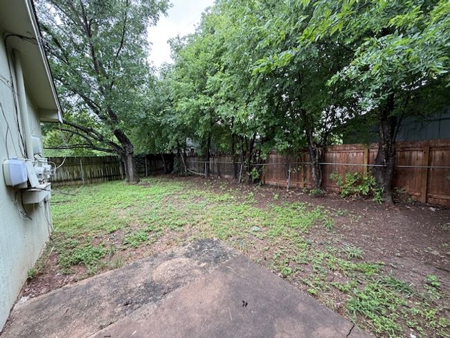 View of fenced backyard | Image 13