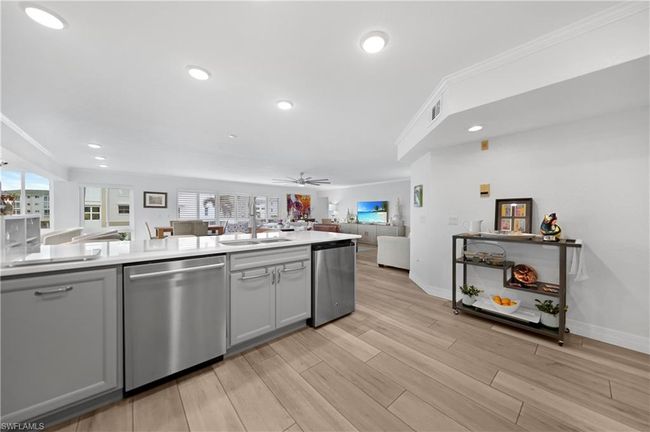Kitchen with ceiling fan, dishwasher, ornamental molding, and sink | Image 9