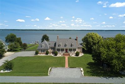 Aerial showing 1.7 acres of riverfront property. Front parking area for guests and side entry 2 car garage with 2 garage door openers. | Image 2