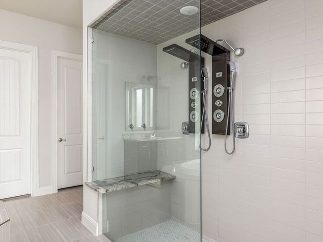 Full bathroom with baseboards and tiled shower | Image 16
